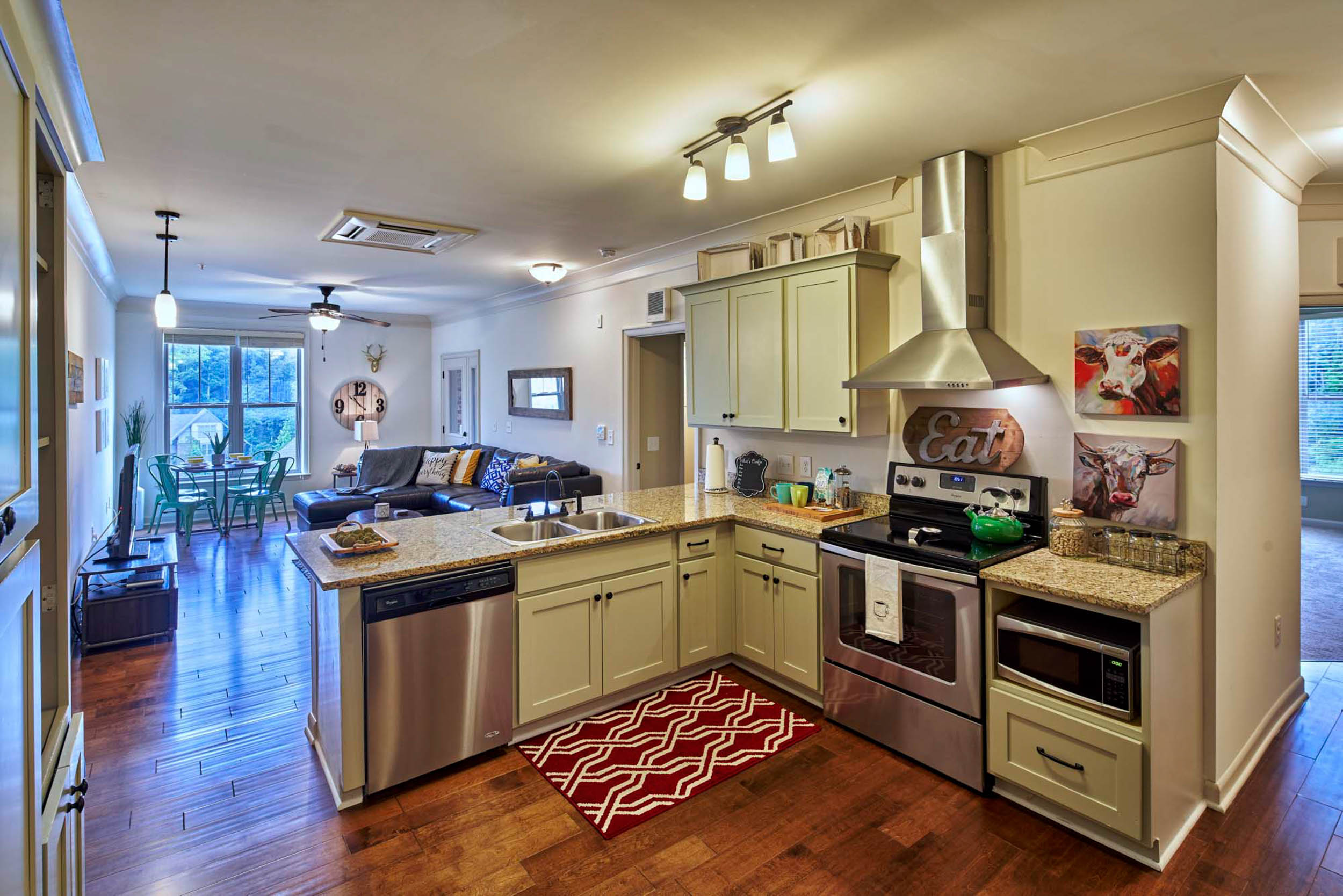 Apartment kitchen with warm beige cabinets and stainless steel appliances