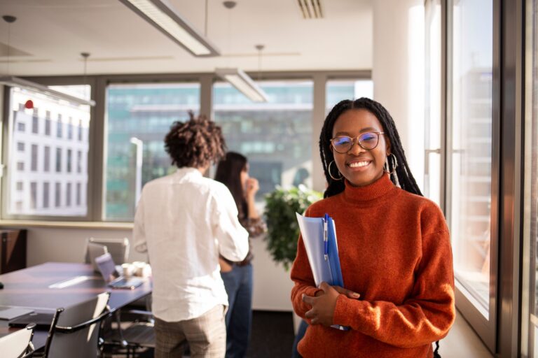 smiling woman holding office folder
