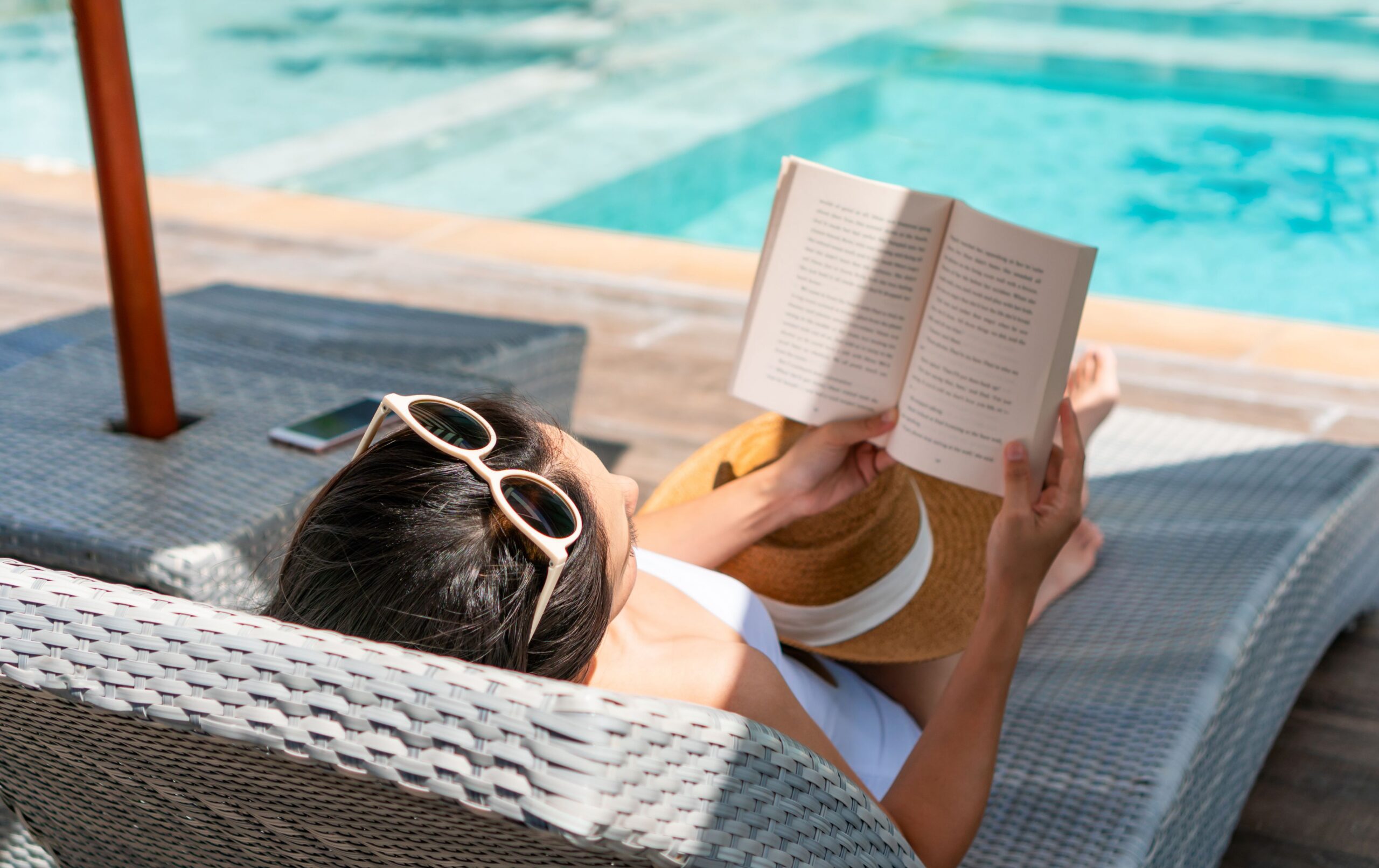 Students studying by the resort-style pool at Arcadia Student Living, an off-campus student apartment complex near UNCC.
